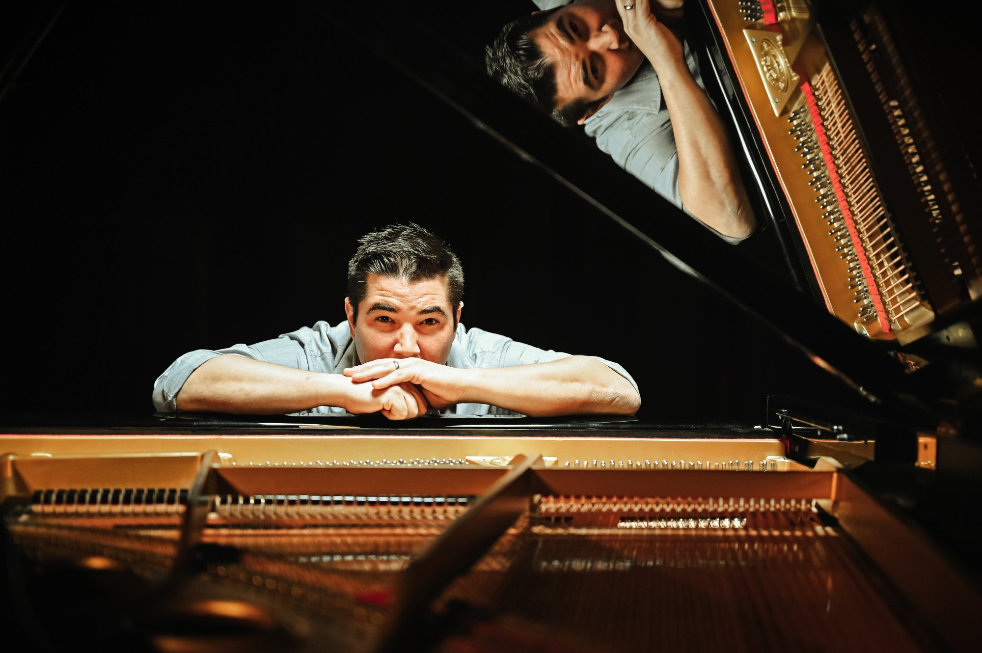 Danny K headshot with piano reflection