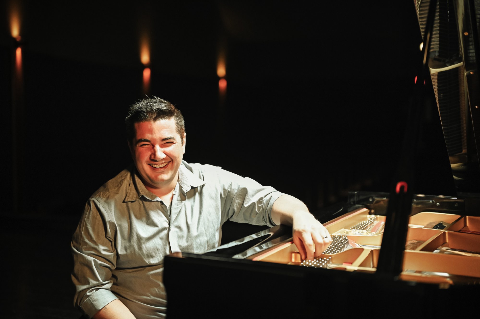 Danny K smiling at the piano